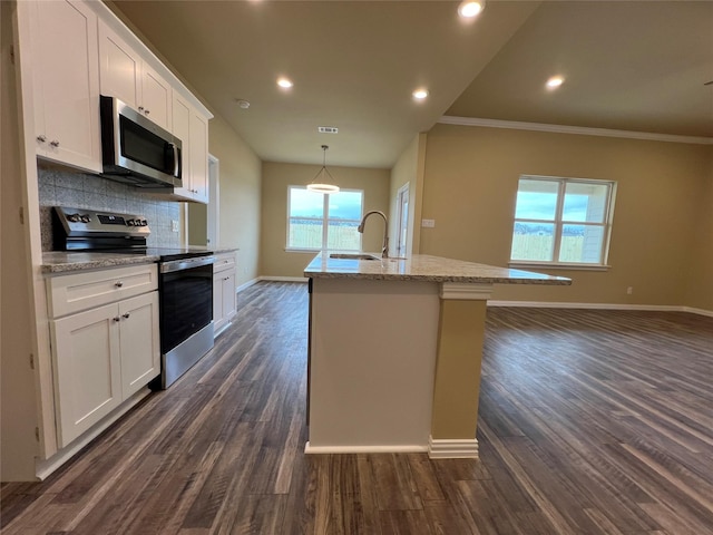 kitchen featuring tasteful backsplash, a sink, appliances with stainless steel finishes, white cabinetry, and dark wood-style flooring