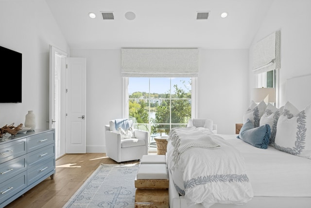 bedroom with recessed lighting, visible vents, lofted ceiling, and wood finished floors