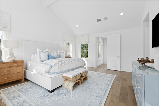 bedroom with visible vents, high vaulted ceiling, wood finished floors, recessed lighting, and baseboards