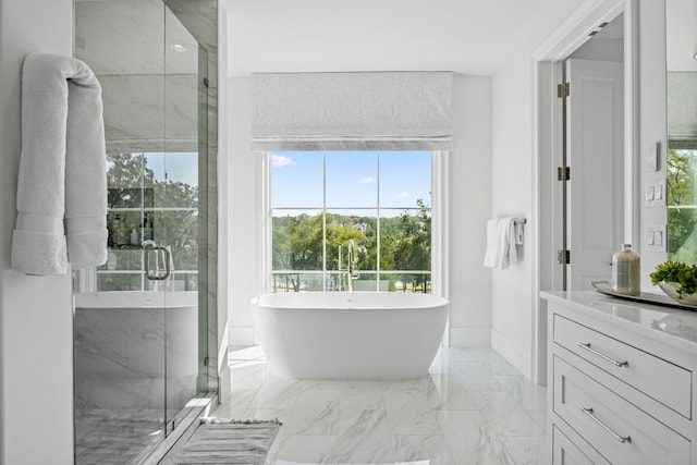 full bathroom with vanity, baseboards, a marble finish shower, a freestanding bath, and marble finish floor