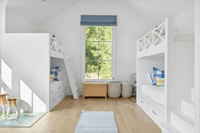 bedroom featuring lofted ceiling and wood finished floors