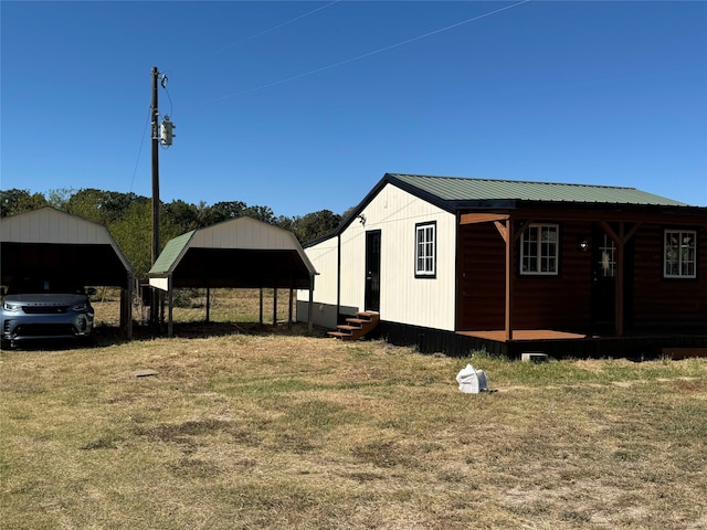 view of side of home with entry steps and metal roof