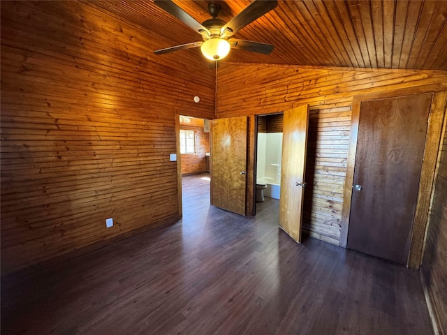 unfurnished bedroom featuring wood ceiling, dark wood finished floors, wood walls, and vaulted ceiling