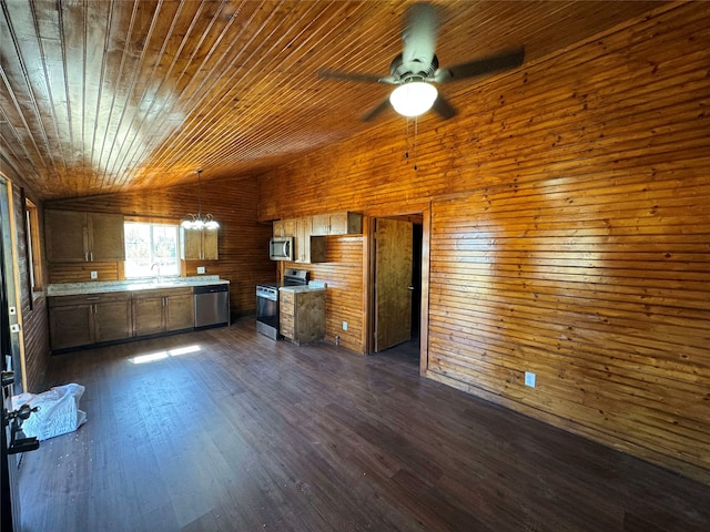 kitchen featuring a sink, light countertops, lofted ceiling, appliances with stainless steel finishes, and dark wood-style flooring