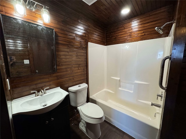 bathroom with vanity, washtub / shower combination, wood walls, wooden ceiling, and toilet