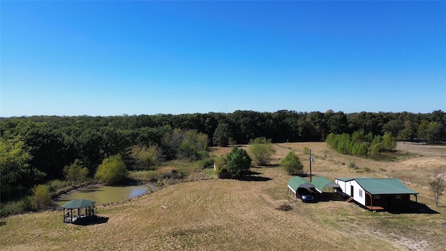 birds eye view of property with a forest view and a rural view