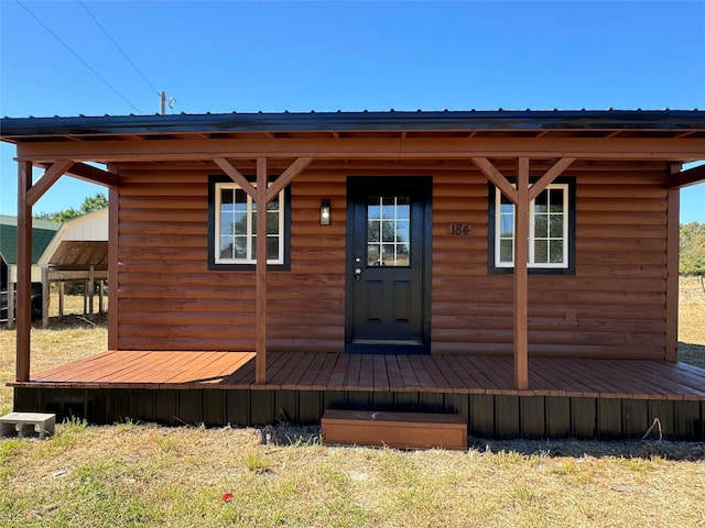 property entrance featuring faux log siding