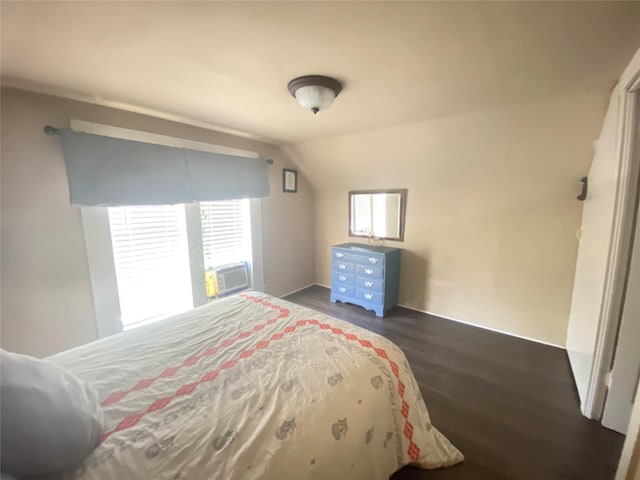 bedroom featuring cooling unit, lofted ceiling, and dark wood-style flooring