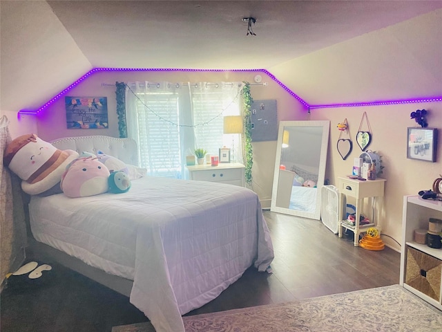 bedroom featuring lofted ceiling and wood finished floors