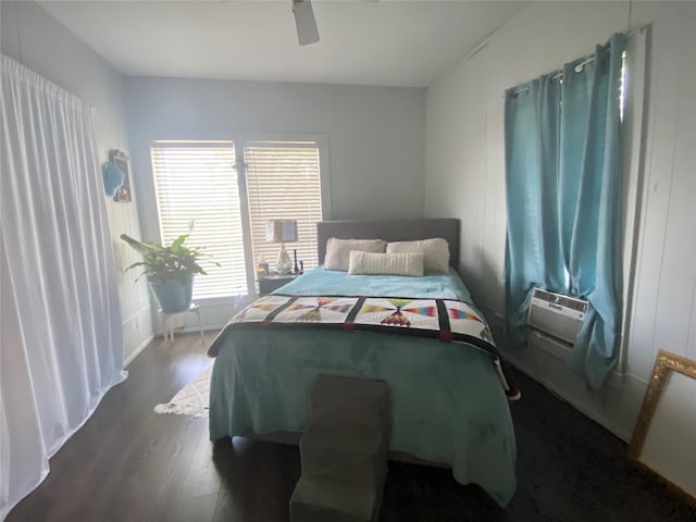 bedroom featuring cooling unit, wood finished floors, and a ceiling fan