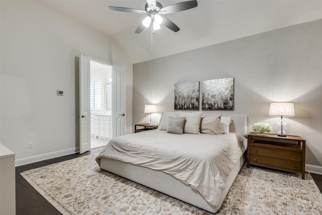 bedroom with lofted ceiling, a ceiling fan, ensuite bath, wood finished floors, and baseboards