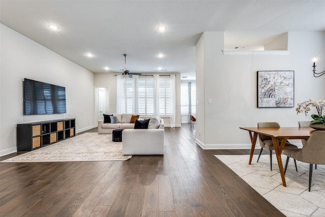 living room with dark wood finished floors, visible vents, recessed lighting, and baseboards