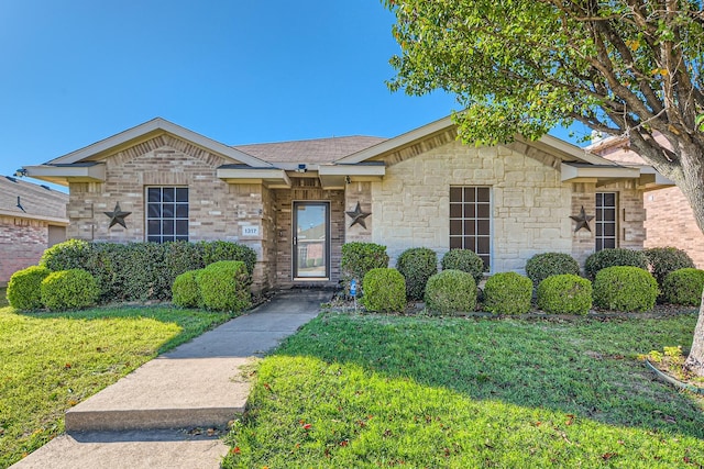 ranch-style home featuring brick siding and a front yard