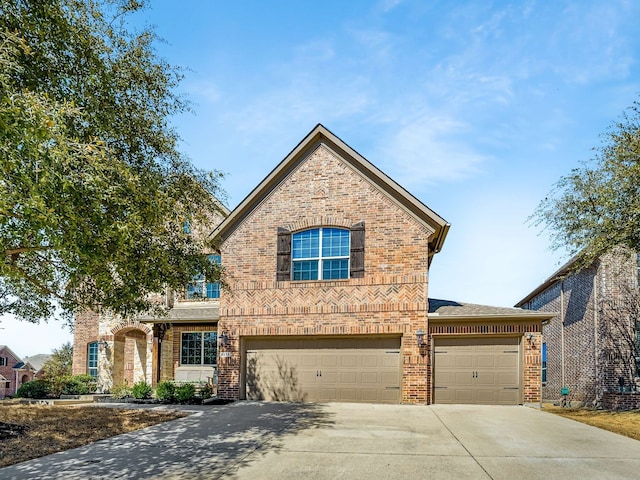 traditional-style house featuring brick siding, concrete driveway, a garage, and a shingled roof