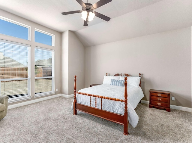 carpeted bedroom with baseboards, a ceiling fan, and vaulted ceiling