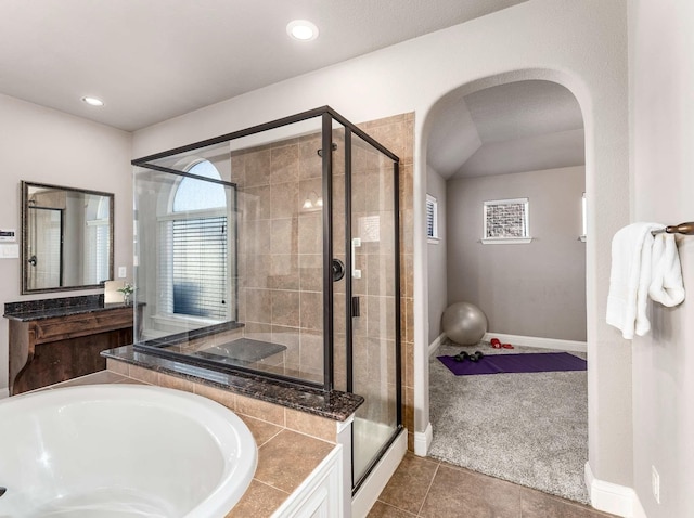 full bath with a shower stall, a bath, baseboards, and tile patterned floors