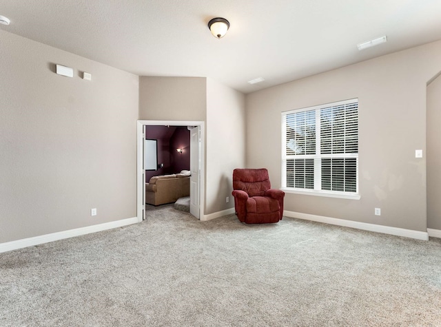 unfurnished room with carpet and baseboards