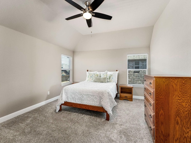 bedroom featuring baseboards, light carpet, and vaulted ceiling