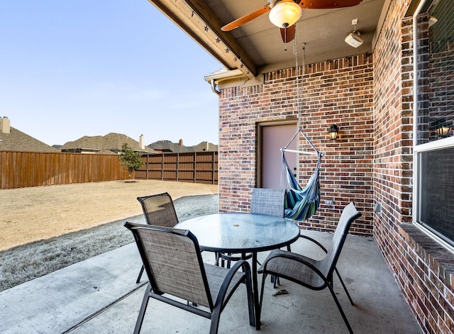 view of patio featuring outdoor dining area, a ceiling fan, and a fenced backyard