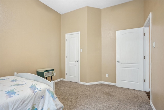 bedroom with baseboards and carpet flooring