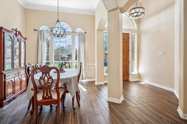 dining area with a chandelier, dark wood-style floors, and baseboards