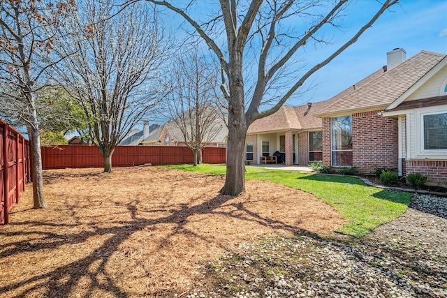 view of yard with a patio area and a fenced backyard