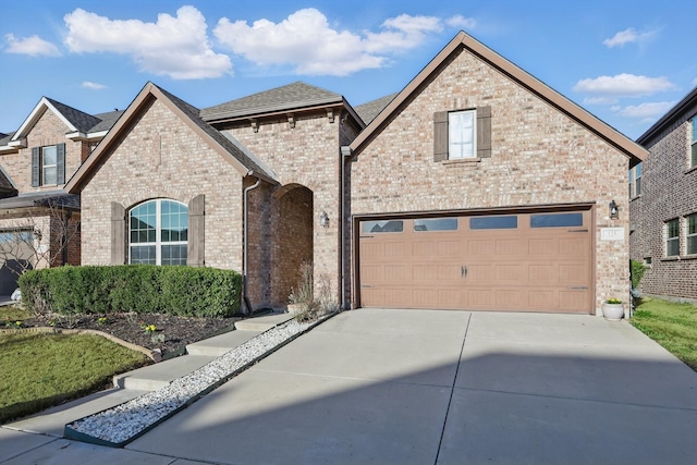 view of front of house with brick siding and driveway