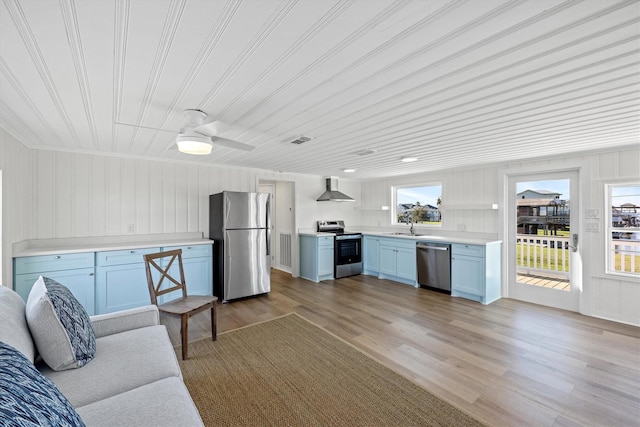 living room featuring visible vents, ceiling fan, and light wood finished floors