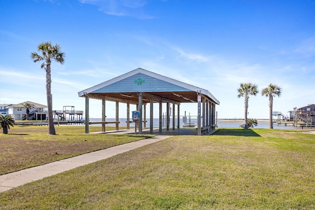 view of community with a water view and a lawn