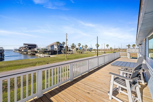 deck featuring a yard and a water view