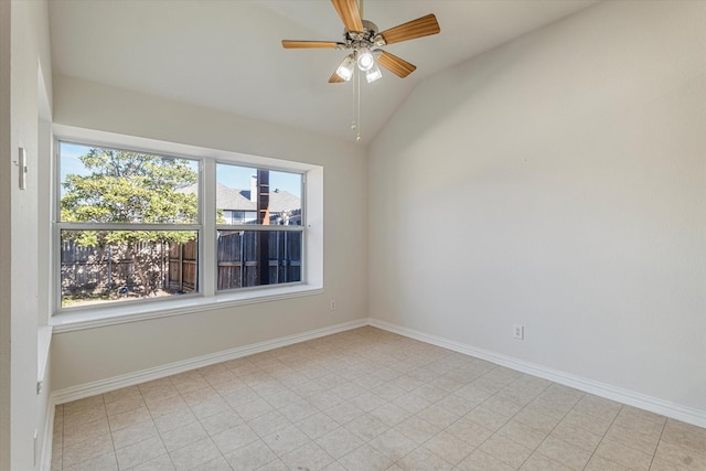 spare room with ceiling fan, baseboards, and vaulted ceiling