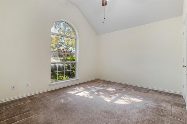 carpeted empty room with ceiling fan and vaulted ceiling