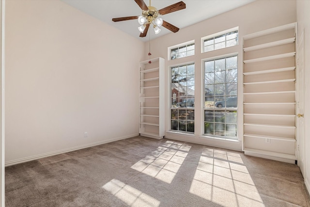 carpeted empty room with baseboards and ceiling fan