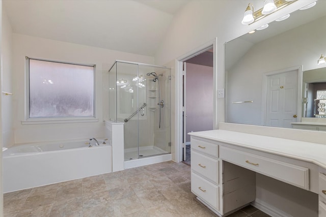 full bath with vanity, lofted ceiling, a bath, and a stall shower