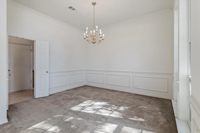 unfurnished room featuring visible vents, crown molding, carpet, a chandelier, and a decorative wall