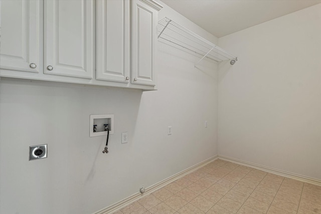 clothes washing area with baseboards, gas dryer hookup, hookup for a washing machine, cabinet space, and electric dryer hookup