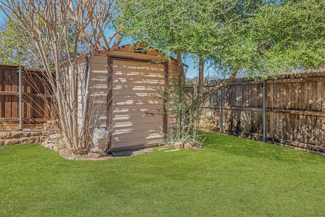 view of yard with a storage unit, a fenced backyard, and an outdoor structure