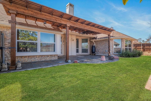 back of property featuring a pergola, a patio, fence, a yard, and a chimney