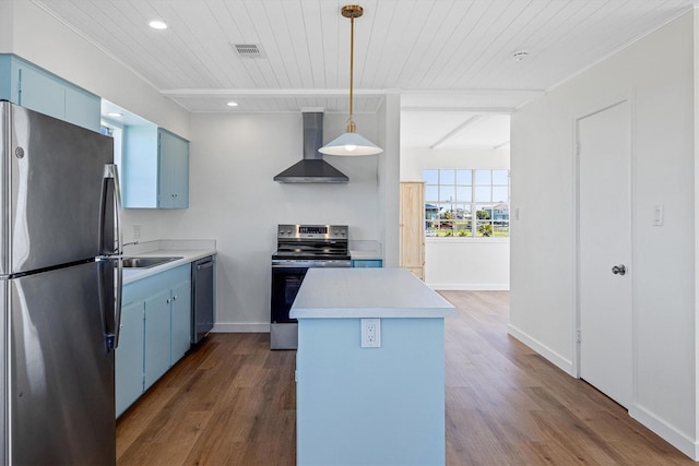 kitchen featuring blue cabinetry, wall chimney exhaust hood, dark wood-style flooring, and stainless steel appliances