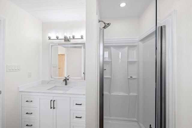 bathroom with vanity, a shower, and ornamental molding