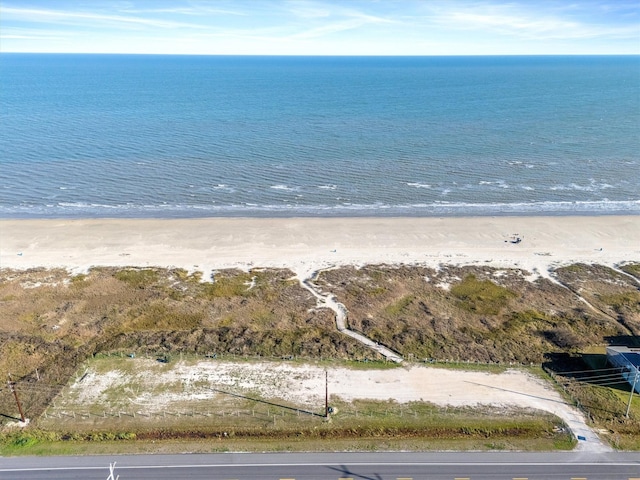 drone / aerial view with a water view and a beach view