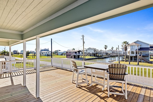 wooden deck featuring a residential view and a water view