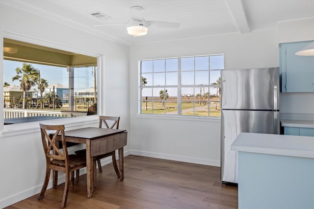 dining room with visible vents, ceiling fan, baseboards, and wood finished floors