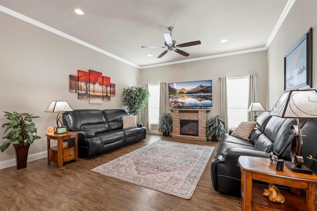 living area with a ceiling fan, wood finished floors, baseboards, and ornamental molding