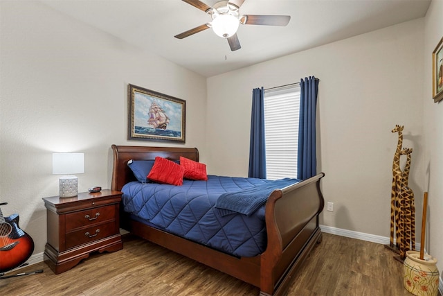 bedroom featuring a ceiling fan, baseboards, and wood finished floors