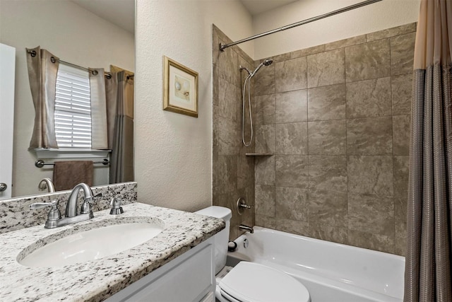 bathroom featuring vanity, toilet, a textured wall, and shower / bath combo with shower curtain