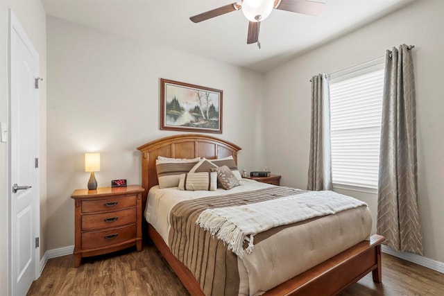 bedroom featuring a ceiling fan, wood finished floors, and baseboards