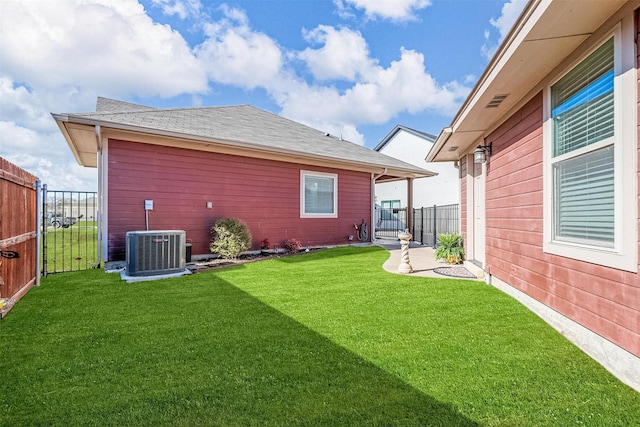 view of yard featuring central AC unit and fence