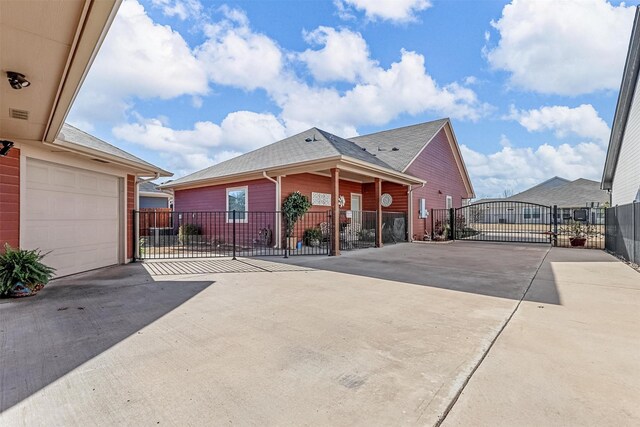 exterior space featuring a gated entry, concrete driveway, and a gate