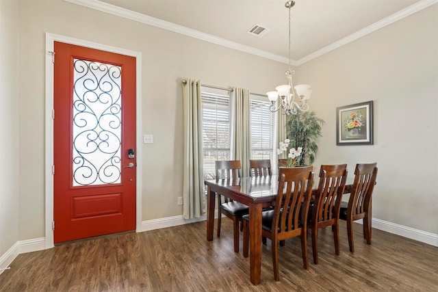 dining area with visible vents, baseboards, dark wood finished floors, and ornamental molding